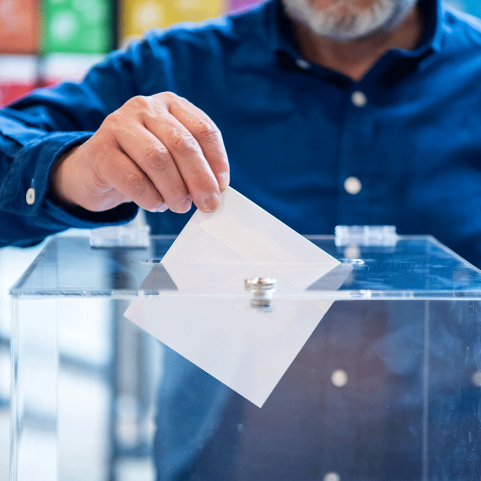 Men in blue shirt voting